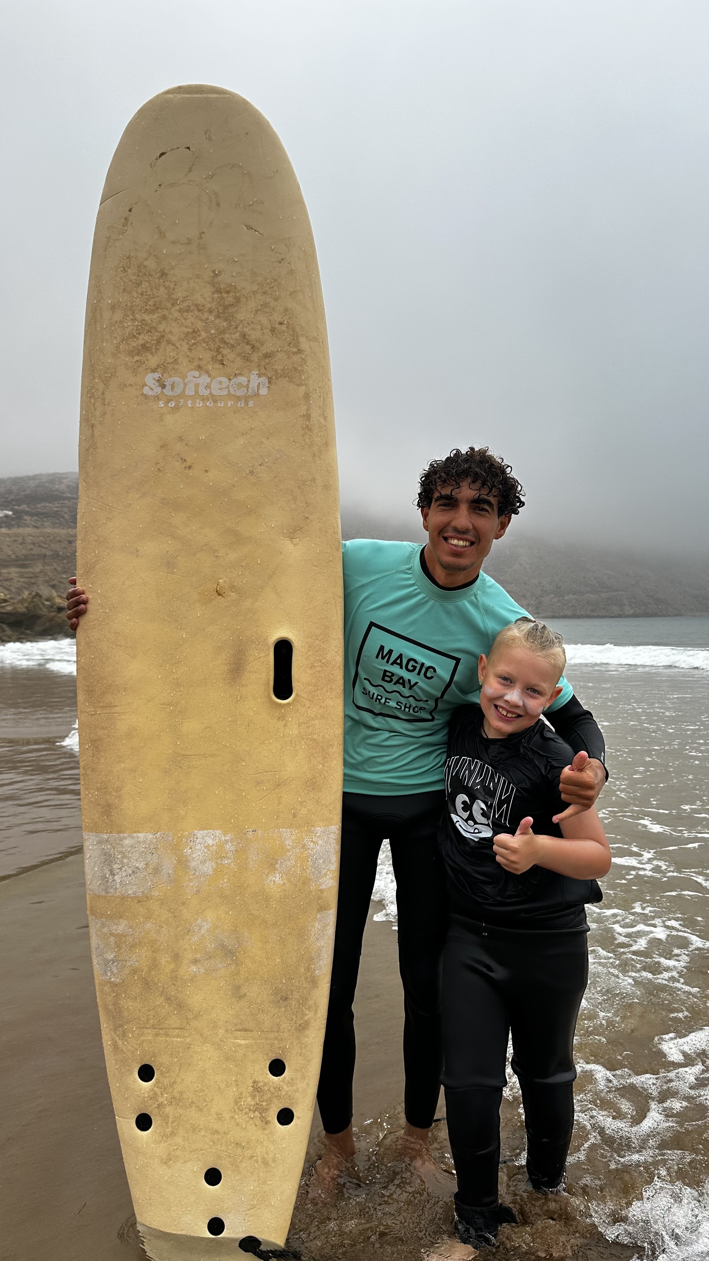 Jax with his surf instructor